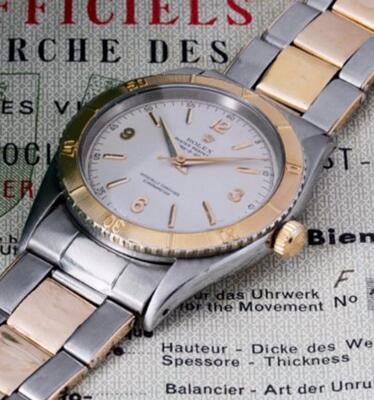 The gold hands and hour markers are striking on the white dial.